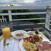 Breakfast with a view! Oatmeal with granola, vegan quiche, whole grain toast, potatoes, vegan cream cheese with nuts & fruit. Soooo good!   at Art of Living Retreat Center in Boone