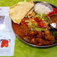 Banana Curry, lentils soup, green peas with tofu, salad with spicy sauces and breads at Cantina Indiana in Lisbon