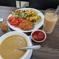 Meal of the day; veggie soup, lentil patty, salad, cauliflower, pear juice drink, strawberry dessert at Soy Vida - Galerías in Bogota