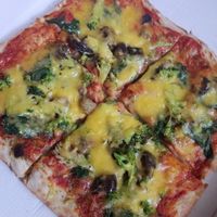 Vegan margherita pizza with aubergine, spinach, and broccoli added at Tradizioni in Cambridge