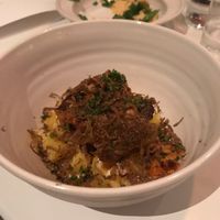 A bed of potatoes with chantarelles and magical truffels on top at Rutabaga in Stockholm