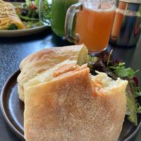 Sausage sandwich, he couldn’t wait to take a bite 🤣😋 at Retreat Kitchen in Richmond Upon Thames