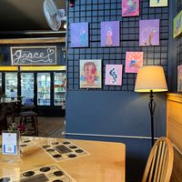 Interior dining area with wall art and fridge case  at Rock Hill Bakehouse Cafe in Glens Falls