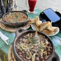 Bean and mushroom tagline (closest) and veggie lentil tagline with orange beet juice   at Le Corail Vegan Food in Essaouira