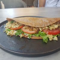Buckwheat crepe with Cashew paste, cauliflower,tomatoes and roquette. at Goodness in Tel Aviv