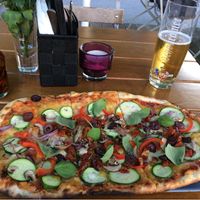 Pizza with vegan cheese, zucchini, peppers, onions, mushrooms and olives at Organic Pizza in Salzburg
