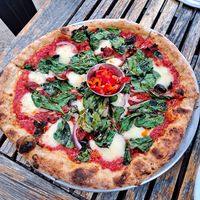Bad Motorfinger Pizza: Crushed tomato, mozzarella (house made from white beans,) sun dried tomato, 'nduja pickled peppers, red onions, olives, spinach😋 at Donna Jean in San Diego