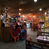 A view of the restaurant with the campervan and swings at Little World in Palolem