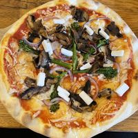 Not keen on the cold cheese chunks sprinkled on top but other a good pizza  at The Stable in Falmouth