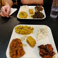 Front plate: BBQ plate with yams, mac and cheese, cornbread and rice. Back plate: Jerk chikin plate with collard greens, mac and cheese, cornbread and rice at Soul Good Vegan Cafe in Durham