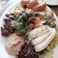 Salad, hummus, cashew camembert, spicy oat sausage, olives, melon at Tea and Happiness in Rotorua