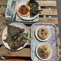 Pizza (top), green quiche (left), focaccias with olives (right)  at Maisie Cafe in Paris