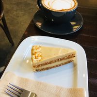 Spiced carrot cake and Oatly cappuccino!  at The V & V Cafe in Glasgow
