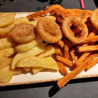 Frittenmix including potato fries, sweet potato fries and onion rings. at Peter Pane - Breite Str in Luebeck