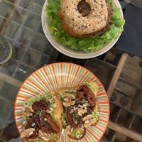 in alto il bagel, sotto l’avocado toast  at Grinder Coffee Lab in Ravenna