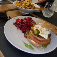 Tofu burger with beetroot and carrot salad and lots of garnish. at Vegan Joe's  in Loule