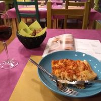 Lasagna, red wine (also vegan) and lots of vegan recipe books to look through. at Cardamomo Cucina Vegana in Arona