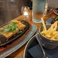 Teriyaki tofu sizzler with fries and a side of olives at Casa Mia in Dumfries