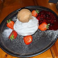 Vegan meringue and ice cream with berries and coulis for dessert at Casa Mia in Dumfries