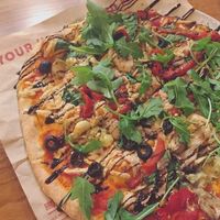 Fully vegan pizza with Daiya cheese, black olives, roasted garlic, spinach, artichokes, mushrooms, caramelized onion, and roasted red pepper. Finished with arugula and balsamic glaze. at Score Pizza in Kingston