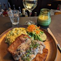 Schnitzel with potato salad at SIGGIS v/gan dine & co. in Munich