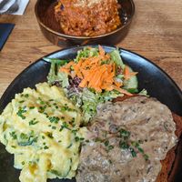 Schnitzel with mushroom sauce and potato salad at SIGGIS v/gan dine & co. in Munich