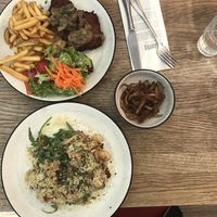 Schnitzel, mushroom risotto, and fried oyster mushrooms at SIGGIS v/gan dine & co. in Munich