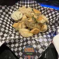 Vegan pierogis with cashew ‘sour cream’, onions and chives. Vegan sticker for extra reassurance 😊   at House of Targ in Ottawa