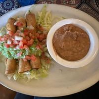 potato taquitos with refried beans   at Hugo's Cocina  in San Diego