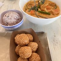 Panang curry with rice and dragon balls  at Grains  in San Diego