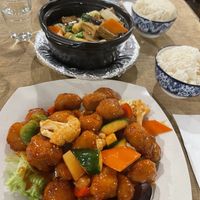 Sweet and sour pork and white rice. In the back, tofu clay pot and coconut rice.  at Vegie Bowl in Springvale