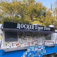 Fun stickered out van behind the truck ! at The Vegan Nom - E Cesar Chavez  in Austin