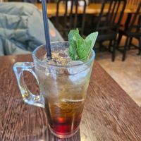 Moose Peach Iced Tea: Peach iced tea served over ice, finished with a sprig of fresh mint. at Moose Coffee in Manchester