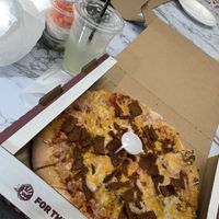 The vegan to-go pizza comes with lettuce & tomato but they put it on the side which I was happy about because I made a salad 🥗   at Roots Pizza in Chicago