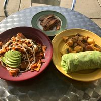 Chilaquiles, breakfast burrito & 2 sides of tempeh bacon  at The Grain Cafe in Long Beach