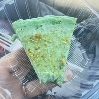 Pistachio cheesecake couldn’t wait to try a bite before I took the picture  at The Grain Cafe in Long Beach