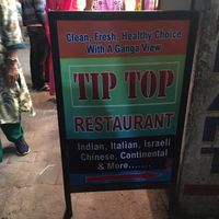 sign on the street path at Tip Top Restaurant in Rishikesh