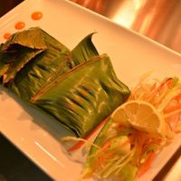 Mushrooms wrapped in banana leaf and cooked on grill.. at Anjanaas in North West London