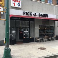 Front of store, with some outdoor seating. at Pick A Bagel in New York City