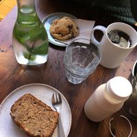 Vegan banana bread, almond milk/date/vanilla drink, cookie and americano  at Otium Cold Press in Paris