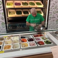 Part of the salad prep area; choice of 10 lettuces on the wall, 28 toppings below. at Greenbeat in Orlando