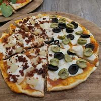 Small vegan pizza. Half chorizo and pineapple/half black and green olives at La Matatena Pizzeria in Oaxaca