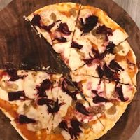Hibiscus flower pizza with almond cheese  at La Matatena Pizzeria in Oaxaca