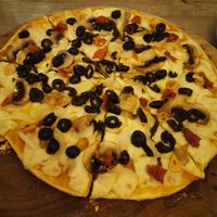 Make your own pizza. Vegan cheese, Olives, garlic, Sundried tomato and mushroom. at La Matatena Pizzeria in Oaxaca