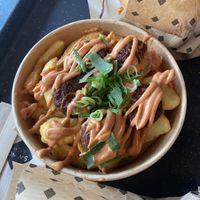 Chick’ n frittes (falafel veg balls on fries with gorgeous Charlie bbq sauce)   at Swing Kitchen - Josefstadt in Vienna