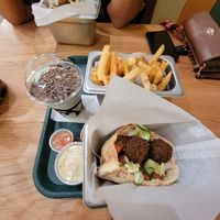 mint chocolate chip milkshake, regular fries (left), shawarma spice fries (right) store made ketchup, store made sauce,falafel sandwich at Goldie - Sansom St in Philadelphia