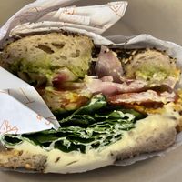 Brekkie bagel with chickpea frittata at Vibe Organic Kitchen & Juice in Newport Beach