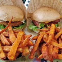 The 'Tribal' and Chick'n burger meals with sweet potato fries at Khambú Quart in Valencia
