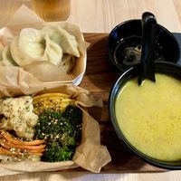 Steamed dumplings with steamed vegetables and soupr cream  at Mo Mo - Saint-Gilles in Brussels