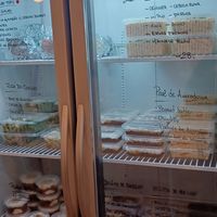 Cold food options. Descriptions on the fridge. Dessert on the bottom shelf. at Vegano SP in Sao Paulo